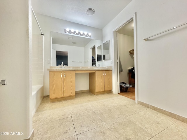 bathroom with tile patterned floors, vanity, tub / shower combination, and baseboards