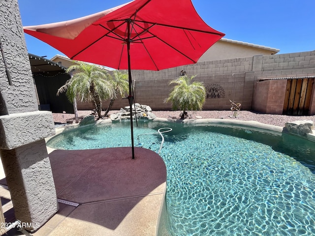 view of pool with a fenced backyard
