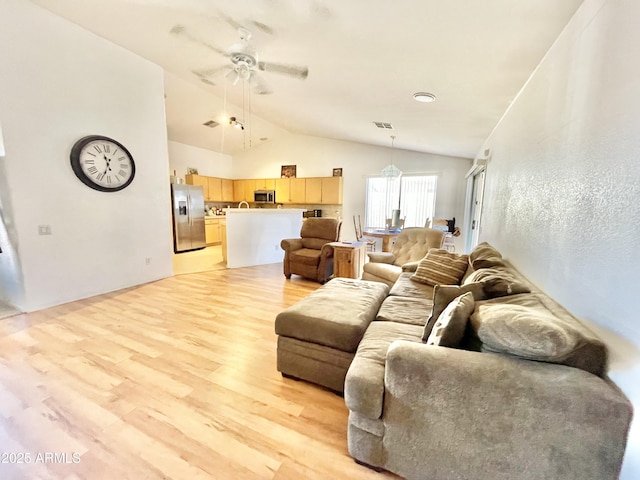 living room featuring light wood-type flooring, lofted ceiling, and ceiling fan