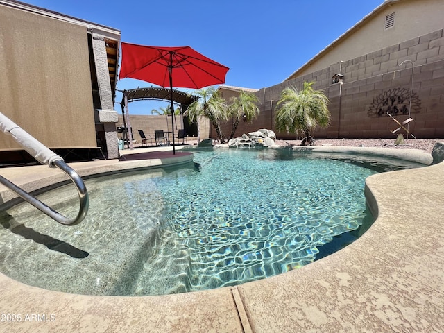 view of pool with a fenced backyard and a patio