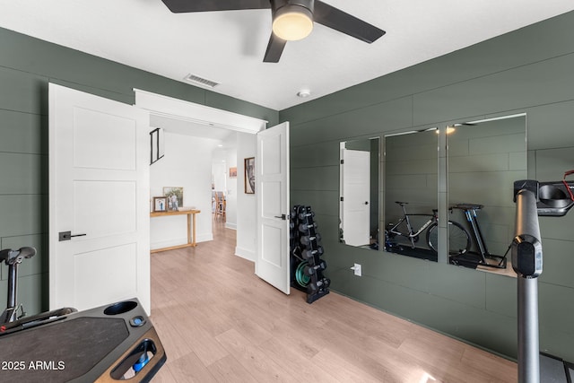 workout room featuring ceiling fan and light wood-type flooring