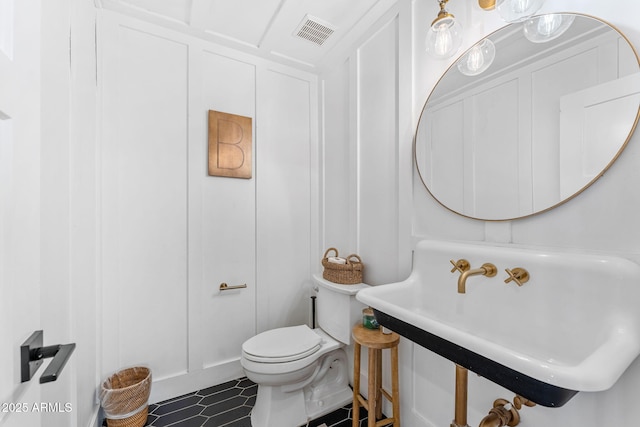 bathroom featuring sink, tile patterned floors, and toilet