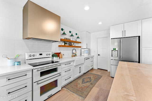 kitchen with sink, backsplash, white cabinets, and white appliances