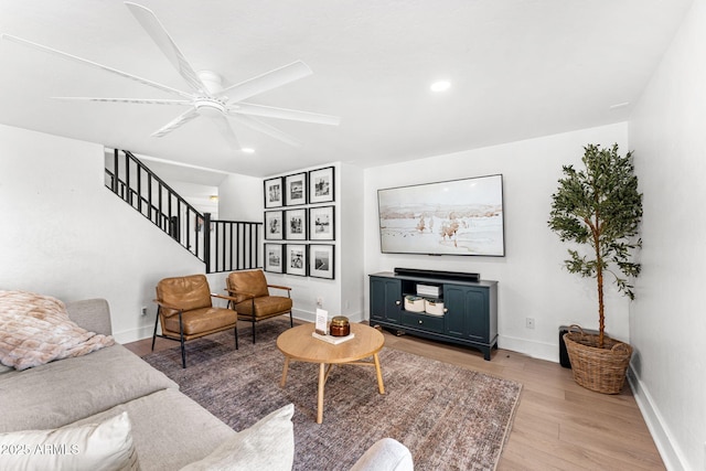 living room with ceiling fan and light wood-type flooring