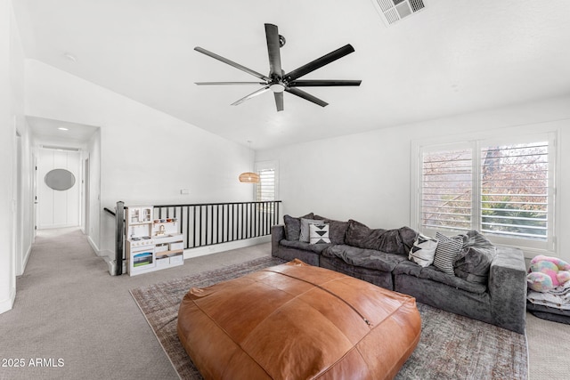 living room featuring lofted ceiling, light colored carpet, and ceiling fan