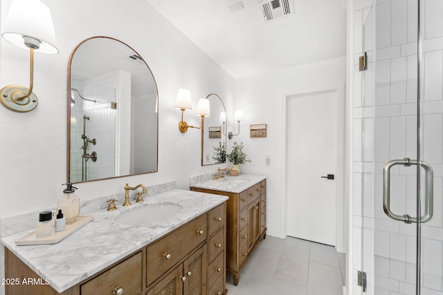 bathroom with tile patterned flooring, an enclosed shower, and vanity