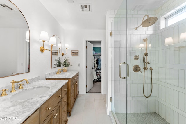 bathroom featuring vanity, tile patterned floors, and walk in shower