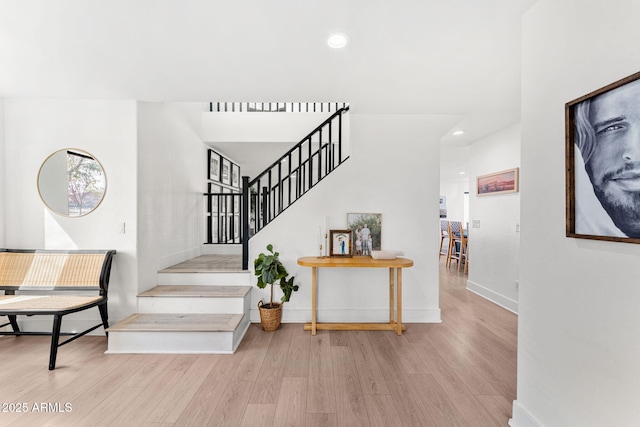 stairs with hardwood / wood-style flooring