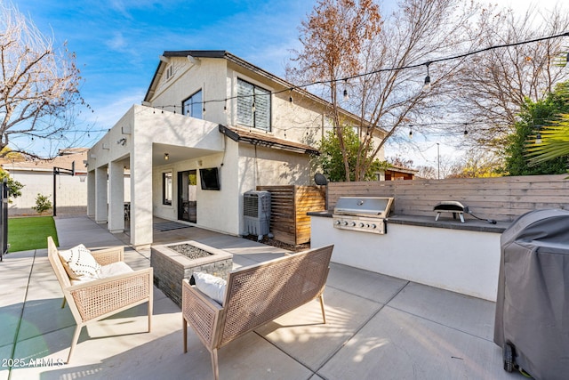 view of patio / terrace featuring area for grilling, a grill, a balcony, and an outdoor fire pit