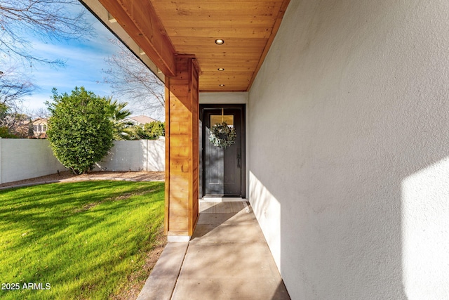 property entrance featuring a lawn