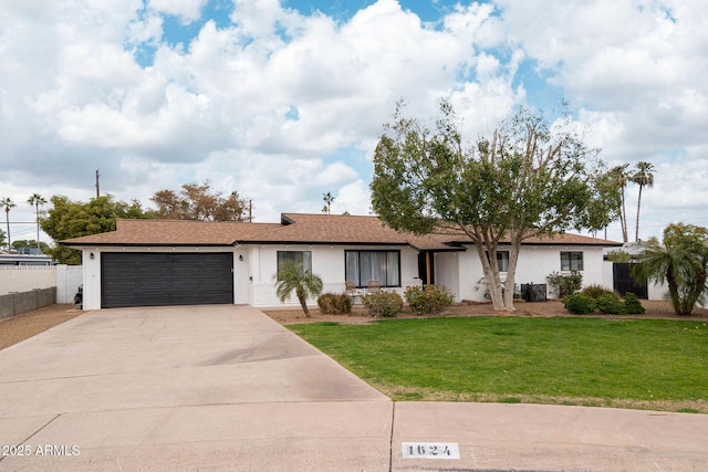 single story home with a garage and a front yard