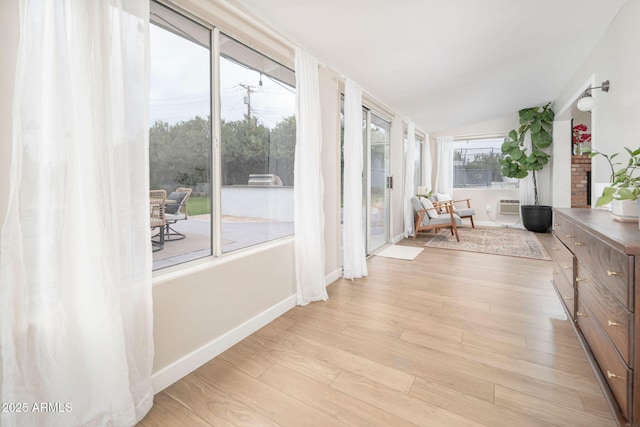 unfurnished sunroom featuring vaulted ceiling