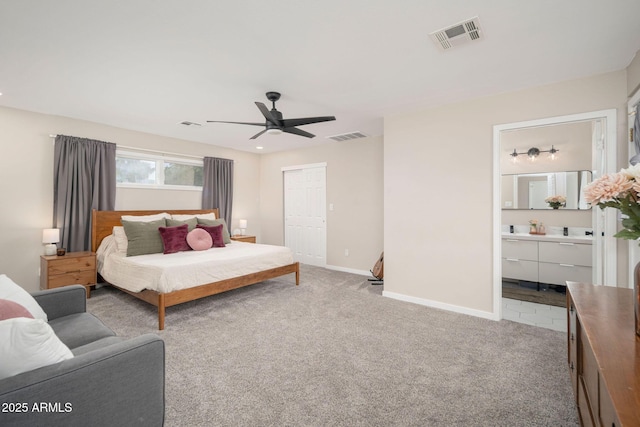 carpeted bedroom with ceiling fan, ensuite bath, and a closet