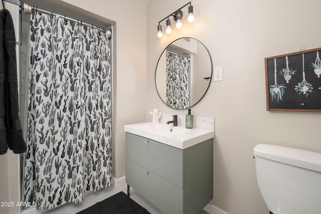 bathroom with tile patterned floors, vanity, toilet, and walk in shower