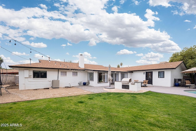 rear view of property featuring area for grilling, cooling unit, a patio area, and a lawn