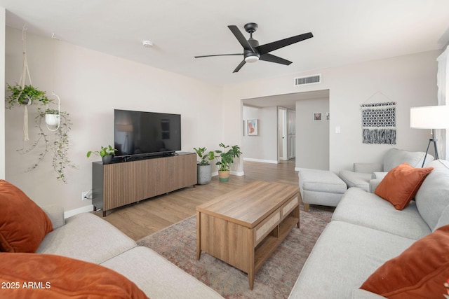 living room featuring light wood-type flooring and ceiling fan