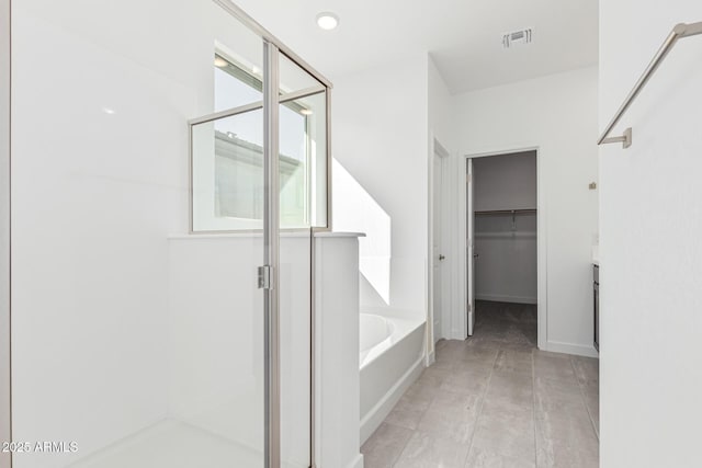 bathroom featuring shower with separate bathtub