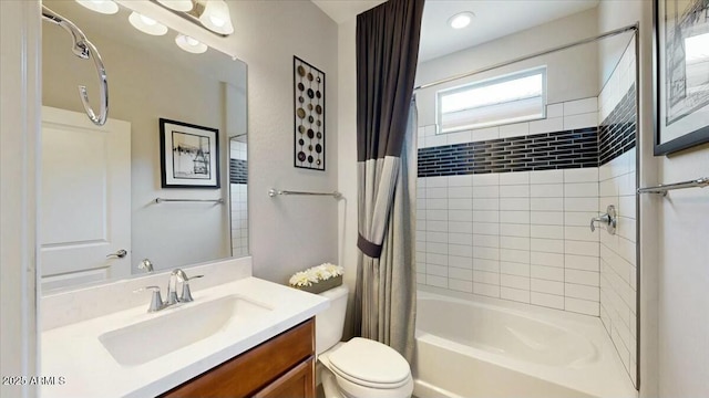 full bathroom featuring toilet, vanity, and shower / bath combination with curtain