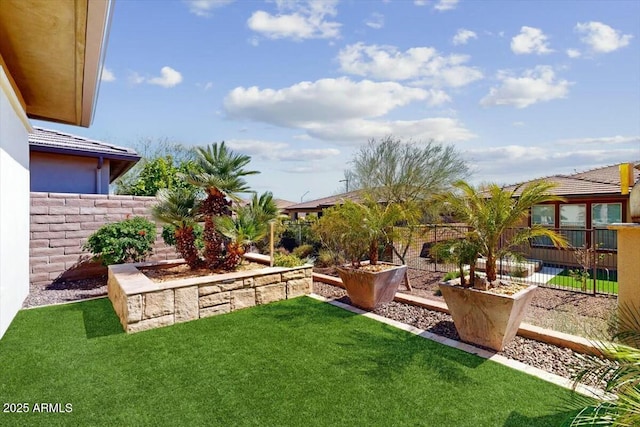 view of yard with a fenced backyard and a garden