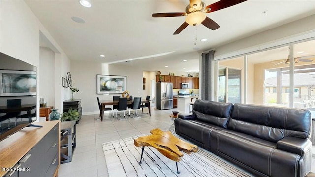 living area with light tile patterned flooring, baseboards, recessed lighting, and ceiling fan