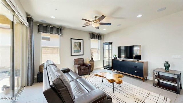 living room with light tile patterned flooring, ceiling fan, baseboards, and recessed lighting