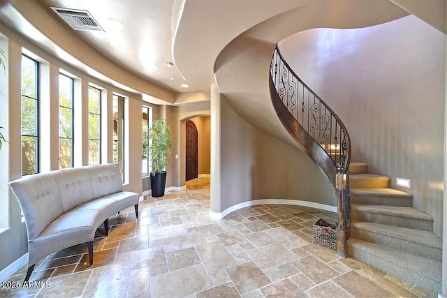 3804 E Camelback Rd, Phoenix, AZ 85018 - foyer entrance with arched walkways, stone tile floors, recessed lighting, and stairs