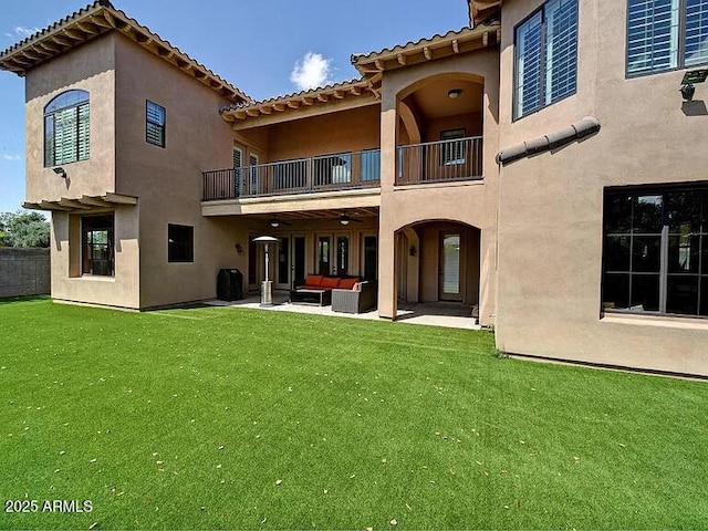 3804 E Camelback Rd, Phoenix, AZ 85018 - back of house featuring a balcony, an outdoor living space, a yard, and stucco siding