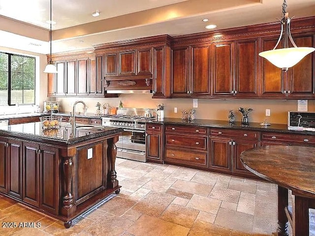 3804 E Camelback Rd, Phoenix, AZ 85018 - kitchen featuring range with two ovens, recessed lighting, a tray ceiling, stone tile floors, and hanging light fixtures