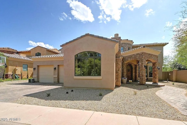 3804 E Camelback Rd, Phoenix, AZ 85018 - mediterranean / spanish house featuring stucco siding, an attached garage, driveway, and a tiled roof