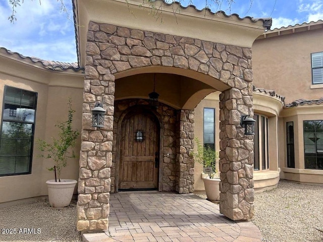 3804 E Camelback Rd, Phoenix, AZ 85018 - entrance to property featuring stone siding, stucco siding, and a tiled roof