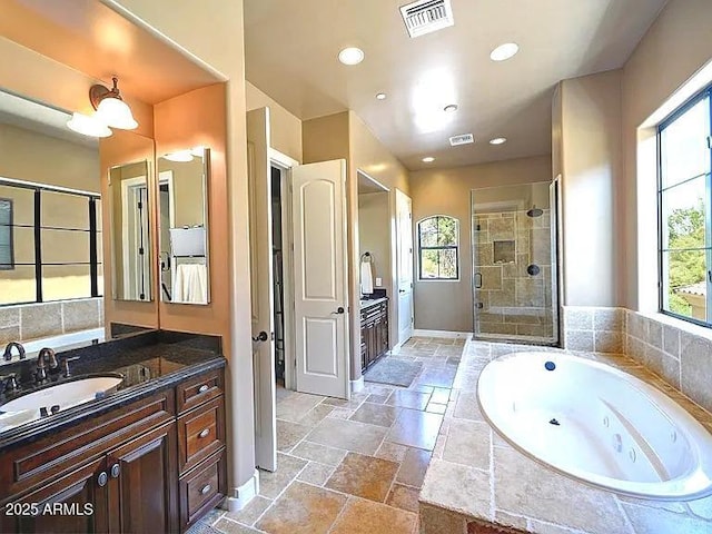 3804 E Camelback Rd, Phoenix, AZ 85018 - bathroom with a stall shower, vanity, a tub with jets, stone tile flooring, and recessed lighting