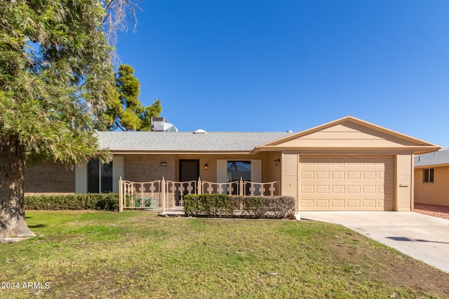 ranch-style house featuring a garage and a front lawn