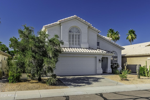 4530 E Desert Wind Dr, Phoenix, AZ 85044 - mediterranean / spanish-style home with a tile roof, driveway, an attached garage, and stucco siding