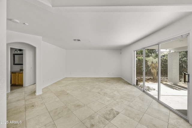 4530 E Desert Wind Dr, Phoenix, AZ 85044 - spare room with light tile patterned floors and arched walkways