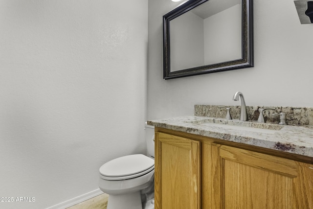 4530 E Desert Wind Dr, Phoenix, AZ 85044 - half bathroom featuring vanity, toilet, and baseboards