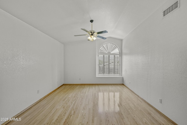 4530 E Desert Wind Dr, Phoenix, AZ 85044 - spare room featuring vaulted ceiling, wood finished floors, ceiling fan, and baseboards