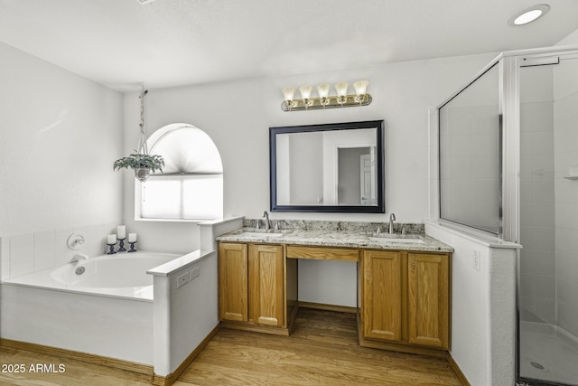 4530 E Desert Wind Dr, Phoenix, AZ 85044 - full bathroom with a garden tub, a stall shower, double vanity, and wood finished floors
