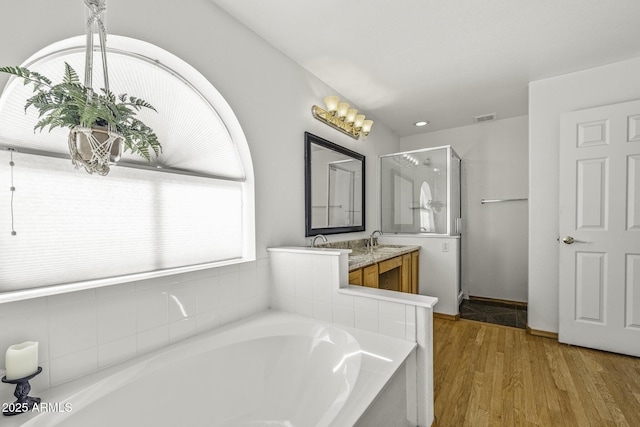 4530 E Desert Wind Dr, Phoenix, AZ 85044 - full bathroom featuring a shower stall, a bath, vanity, and wood finished floors