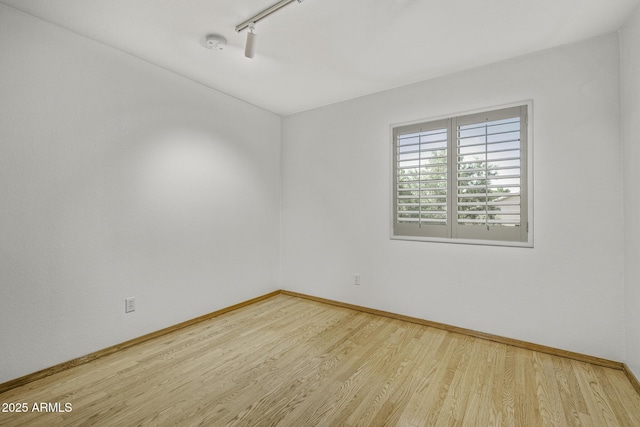 4530 E Desert Wind Dr, Phoenix, AZ 85044 - spare room with track lighting, wood finished floors, baseboards, and a smoke detector