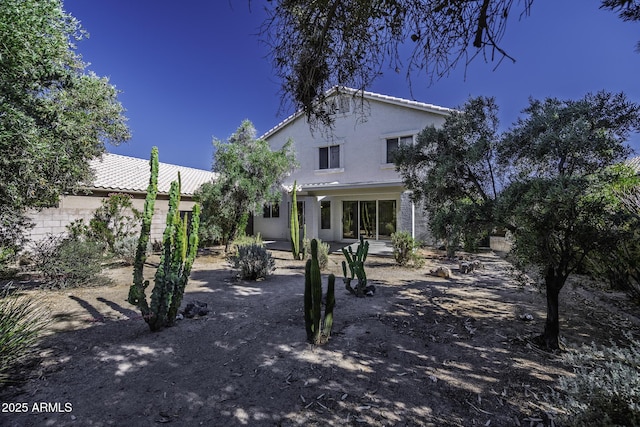 4530 E Desert Wind Dr, Phoenix, AZ 85044 - back of property with stucco siding, a tile roof, and a patio area