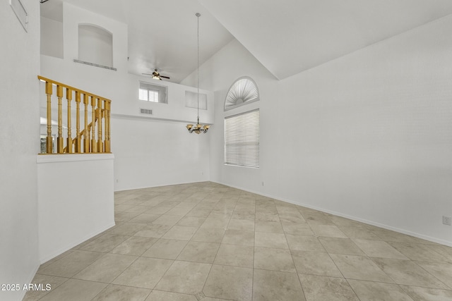 4530 E Desert Wind Dr, Phoenix, AZ 85044 - unfurnished room with high vaulted ceiling, tile patterned floors, a ceiling fan, a chandelier, and baseboards