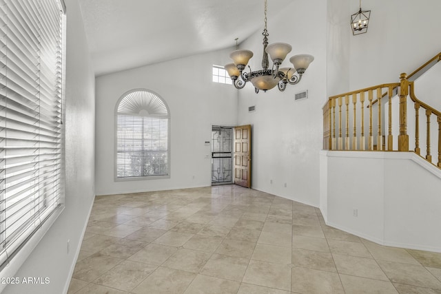 4530 E Desert Wind Dr, Phoenix, AZ 85044 - unfurnished room with a chandelier, tile patterned flooring, high vaulted ceiling, and stairs