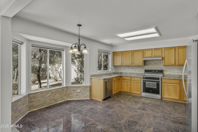 4530 E Desert Wind Dr, Phoenix, AZ 85044 - kitchen with appliances with stainless steel finishes, under cabinet range hood, a sink, light countertops, and pendant lighting
