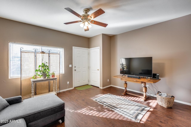 living room featuring hardwood / wood-style flooring and ceiling fan