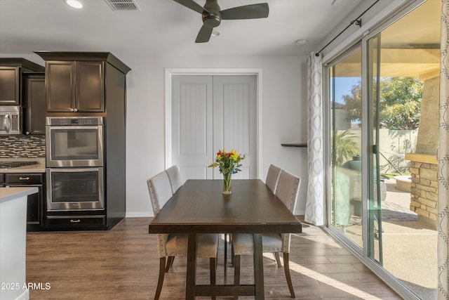 dining space with dark hardwood / wood-style floors and ceiling fan