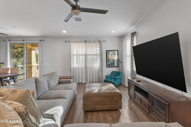 living room with hardwood / wood-style flooring and ceiling fan