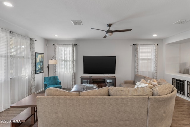 living room featuring wood-type flooring, a wealth of natural light, and ceiling fan