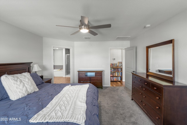 bedroom with ceiling fan, carpet floors, and ensuite bath