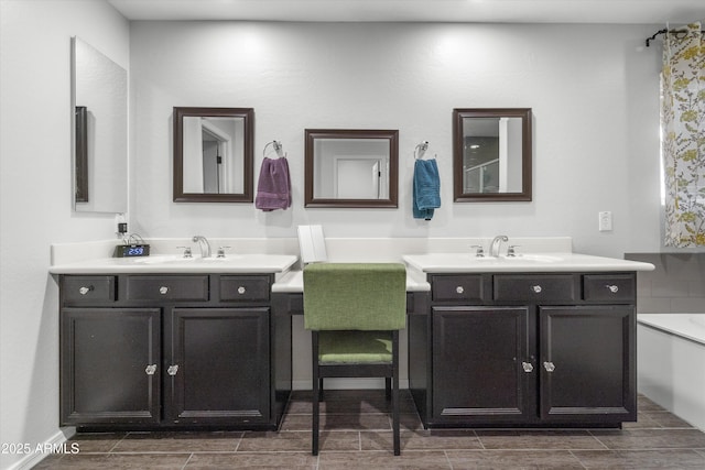 bathroom featuring vanity and a tub