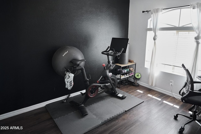 2930 W La Salle St, Phoenix, AZ 85041 - workout room featuring a textured wall, baseboards, and wood finished floors